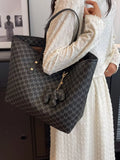 Dark monogram vegan leather tote with wide opening, top handles, and chain charm