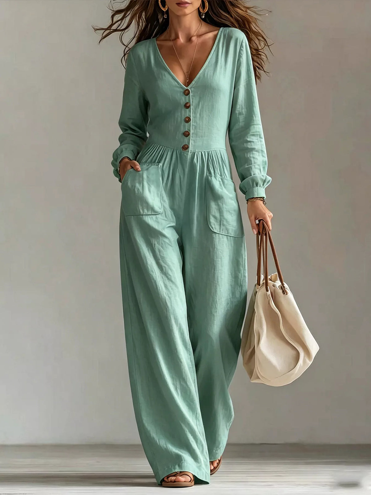 Mint green v-neck button-front wide-leg jumpsuit with long sleeves and pockets