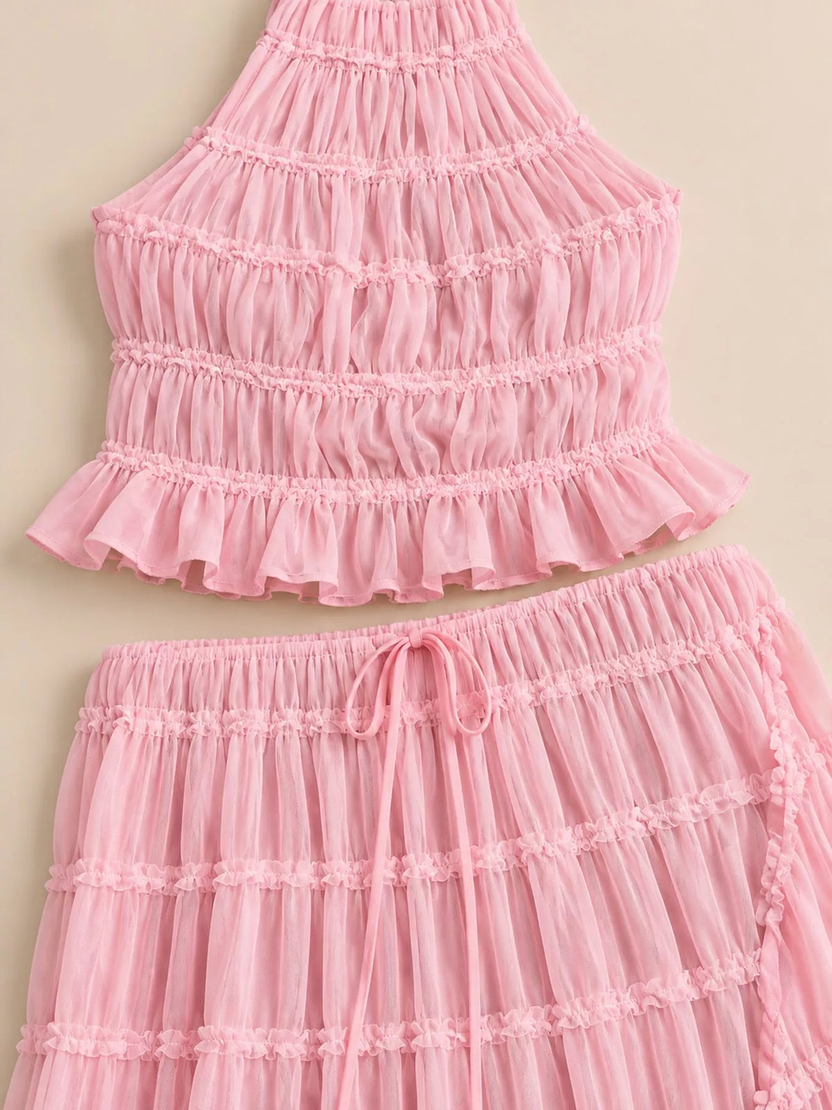 Pink halter ruffle crop top and tiered maxi skirt set with bow detail