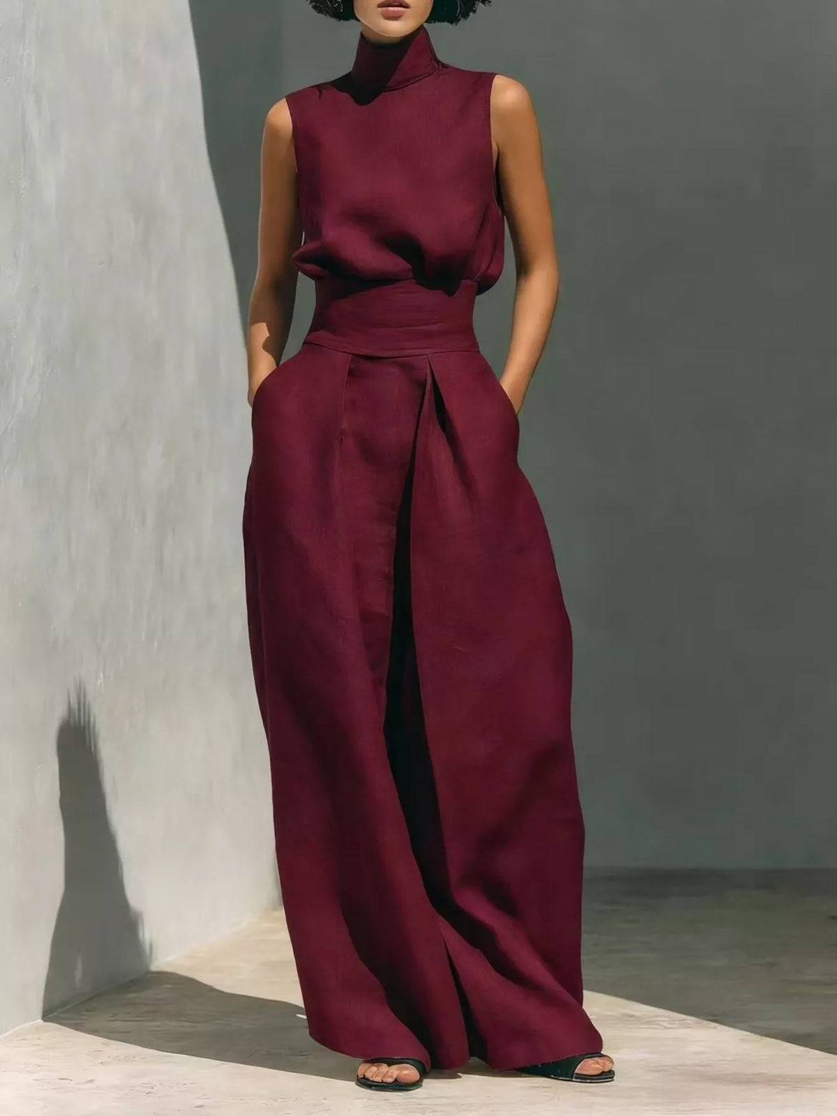 Sleeveless wide-leg jumpsuit in wine red with smocked waist and high neckline
