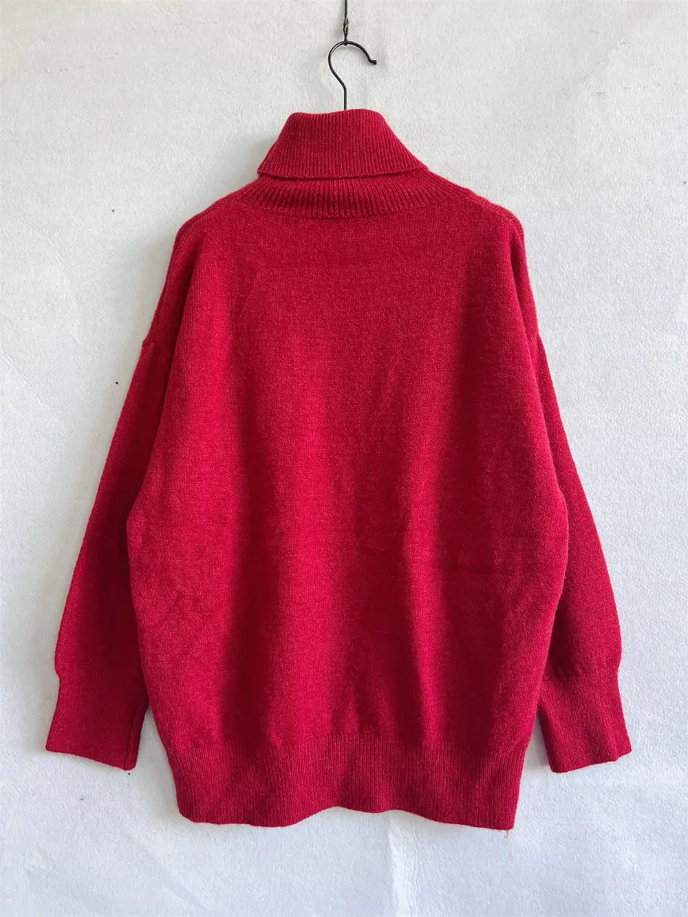 Red turtleneck long sleeve sweater on hanger, back view