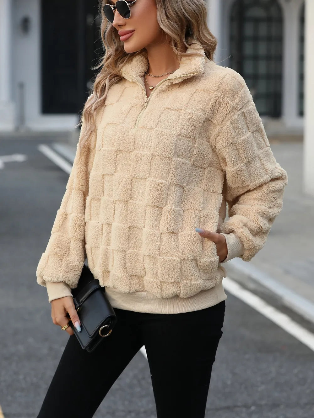Tan fuzzy quarter-zip sweatshirt, check-textured fleece, stand collar detail.