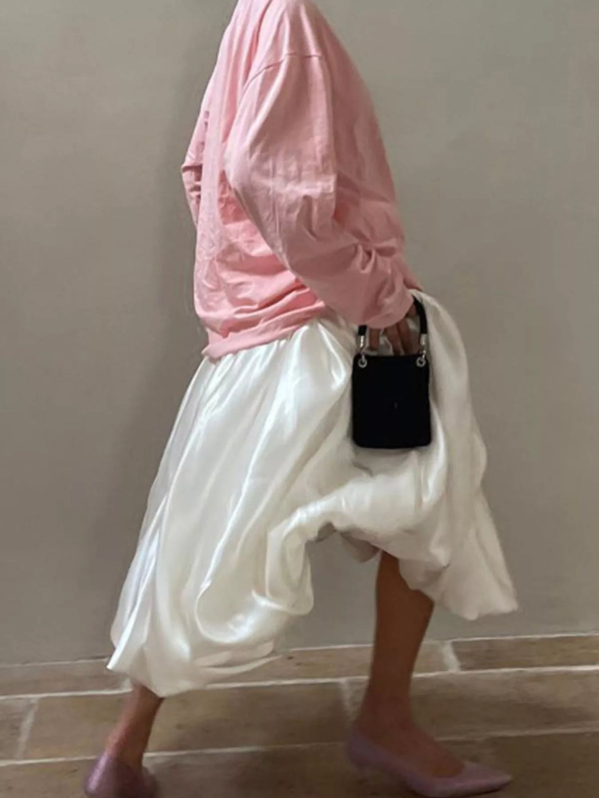 Light pink satin maxi skirt with back zipper and layered, draped hem