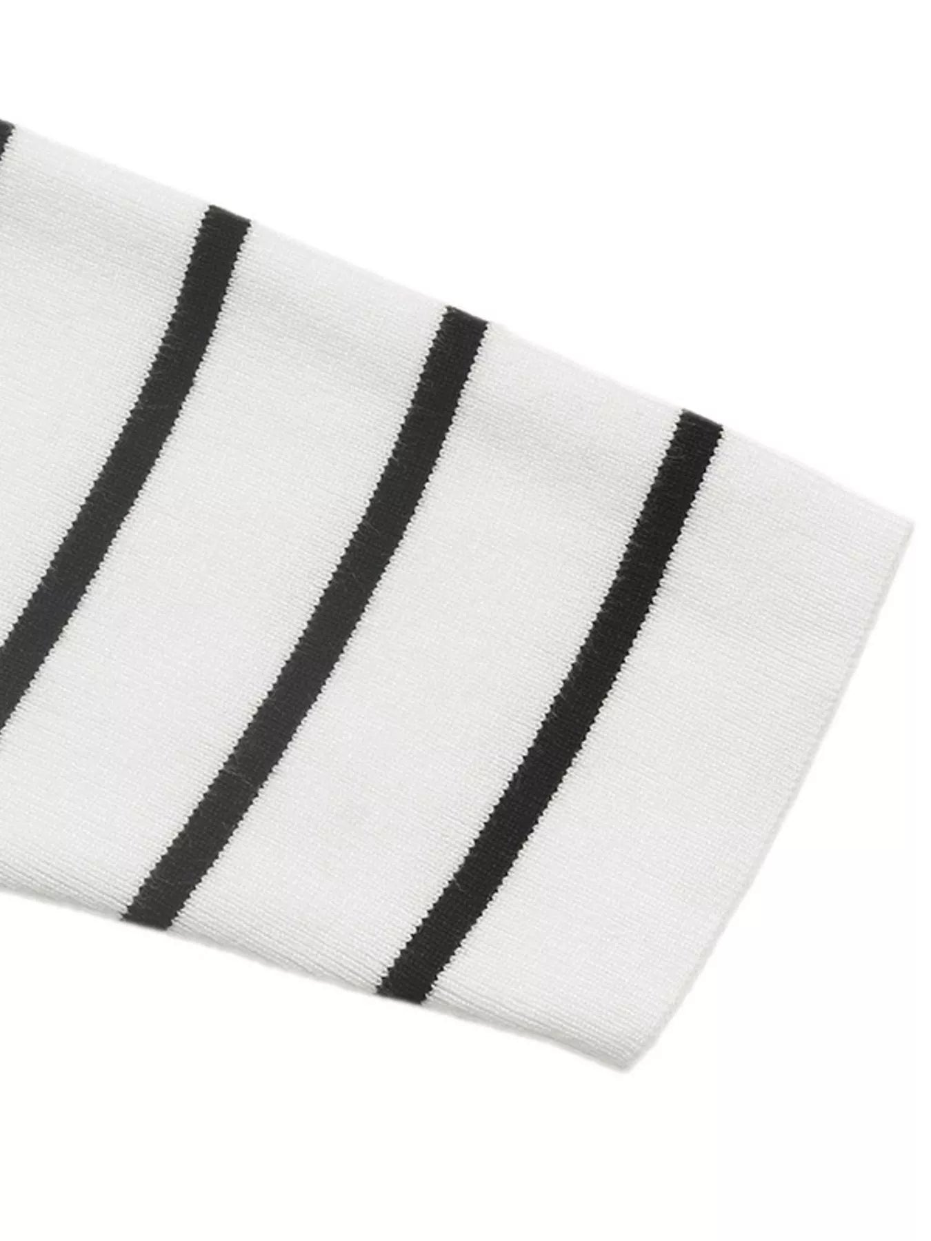 White sweater sleeve cuff with black vertical stripe bands in rib knit