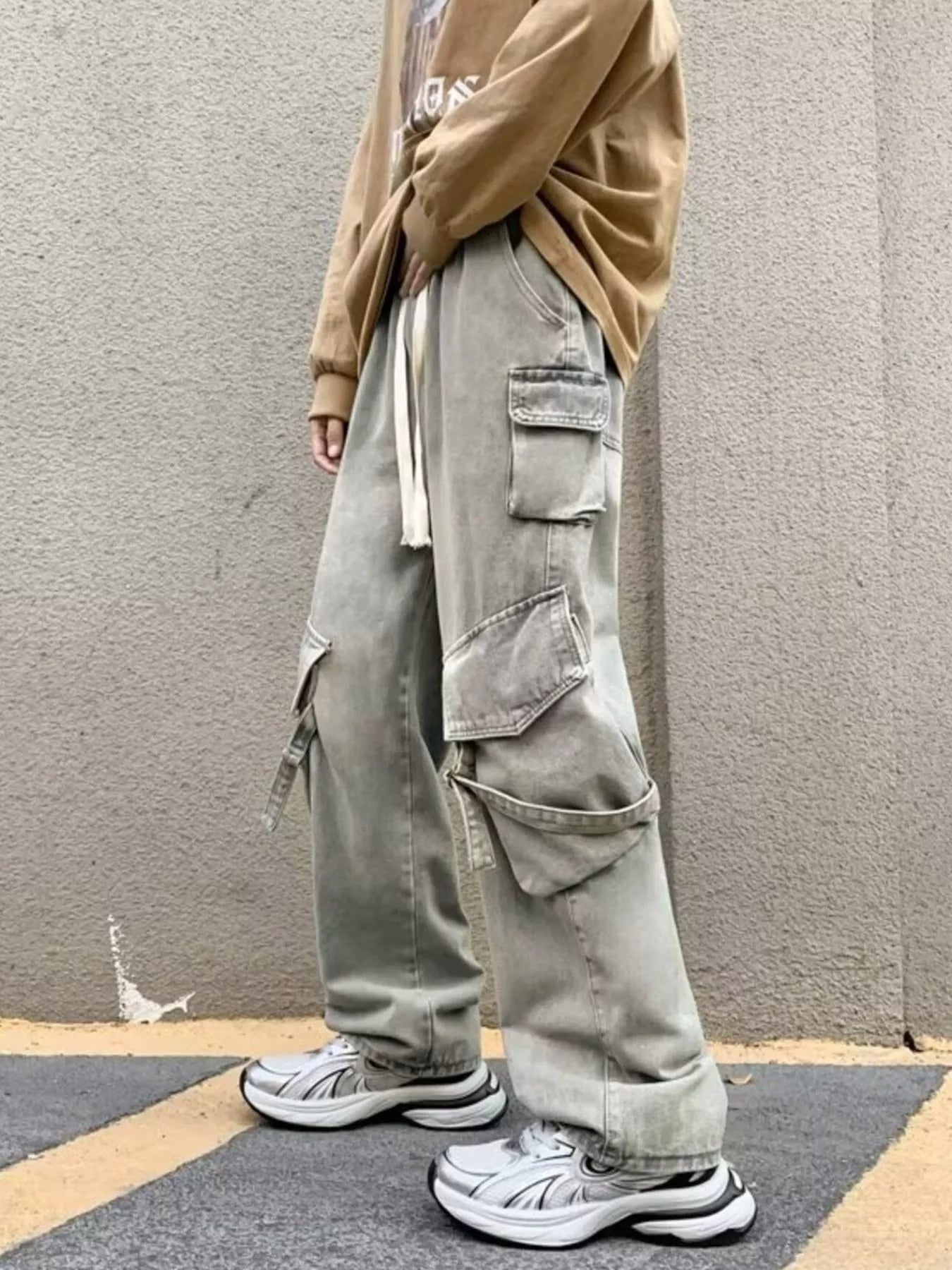 Light gray wide-leg cargo jeans with drawstring waist and large side cargo flap pockets
