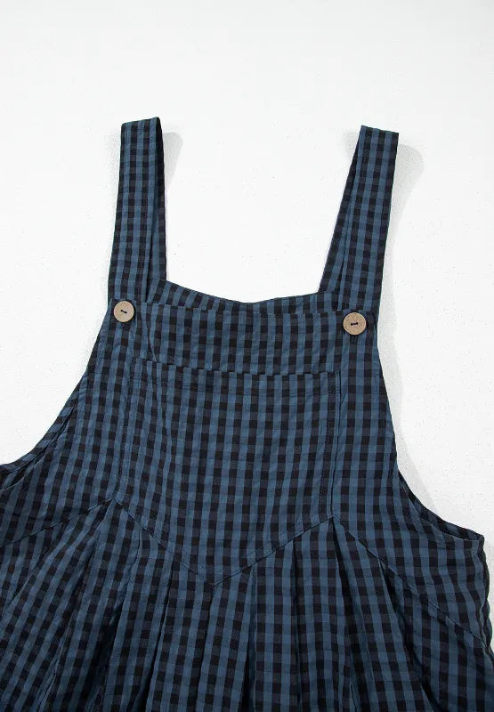 Dark blue plaid overalls bib with wide straps and round button closures