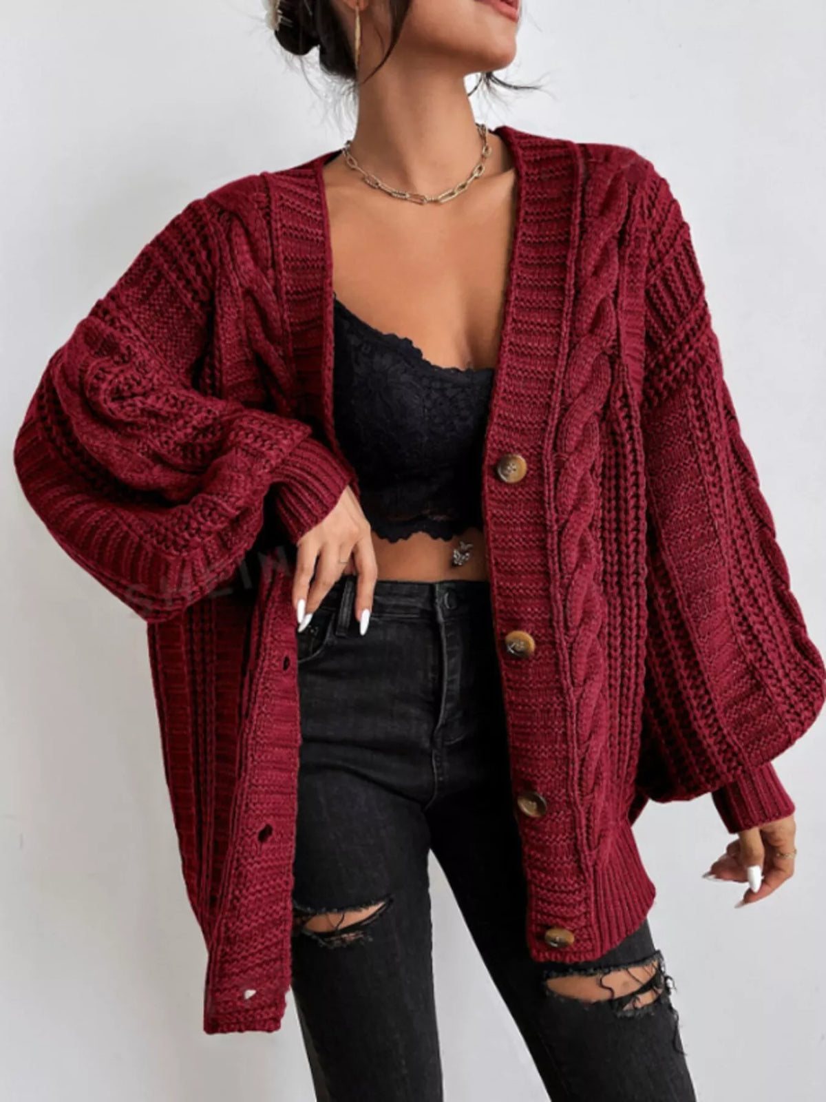 Red oversized cable-knit V-neck button cardigan with long sleeves and ribbed cuffs