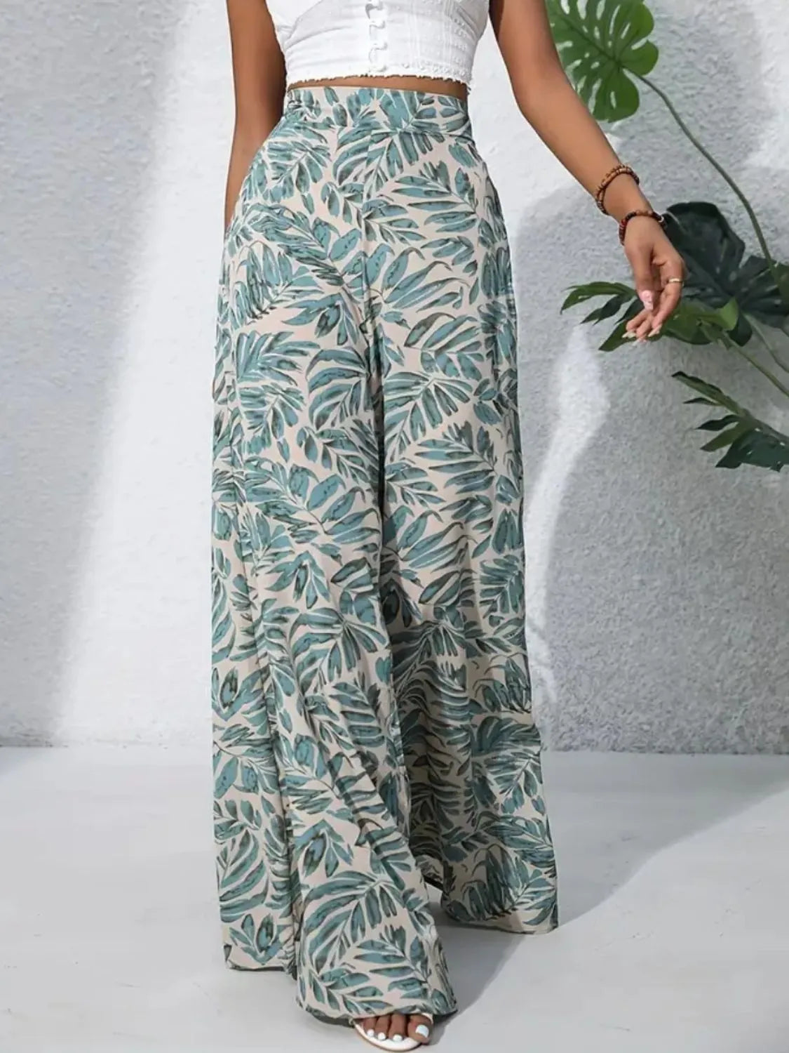 High-waist wide-leg pants with teal-and-cream leaf print and loose wide fit