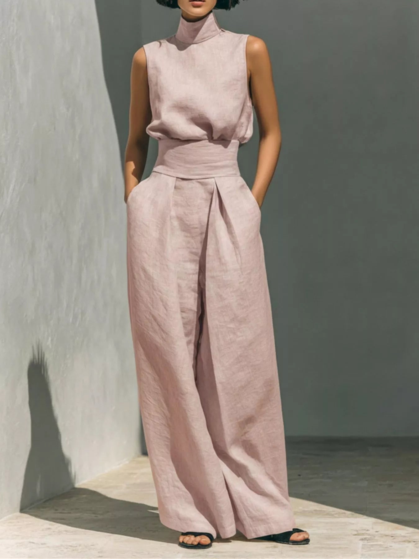 Blush pink sleeveless turtleneck top with front waist knot and wide-leg pants