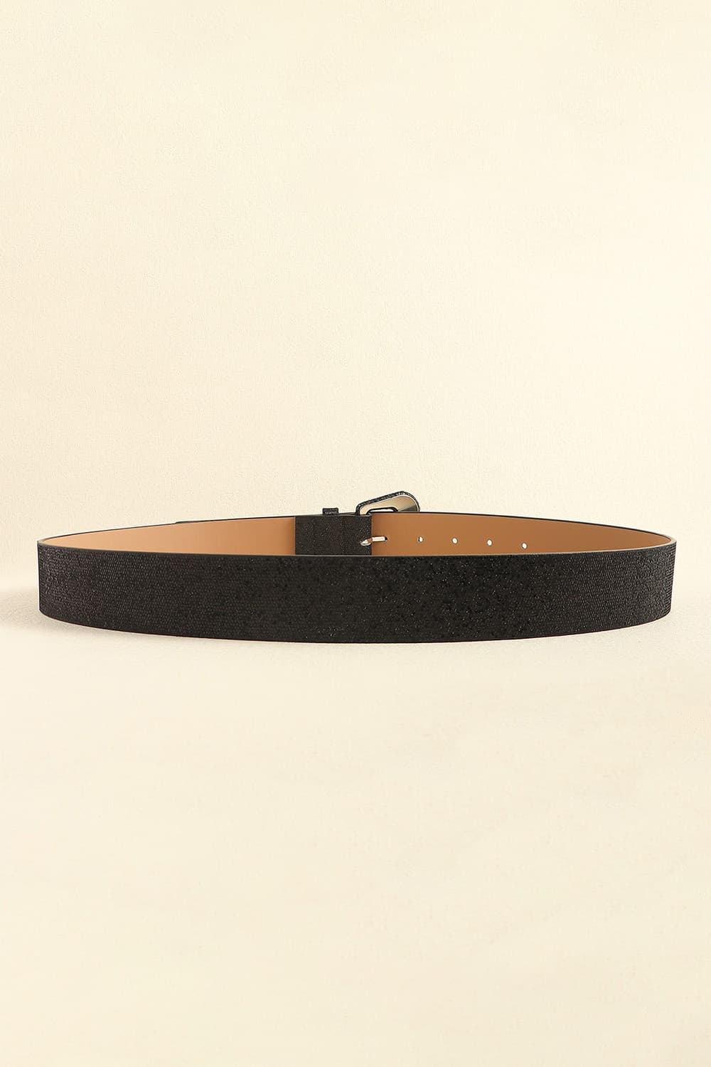 Black glitter vegan leather belt with tan underside and rectangular buckle, flat lay