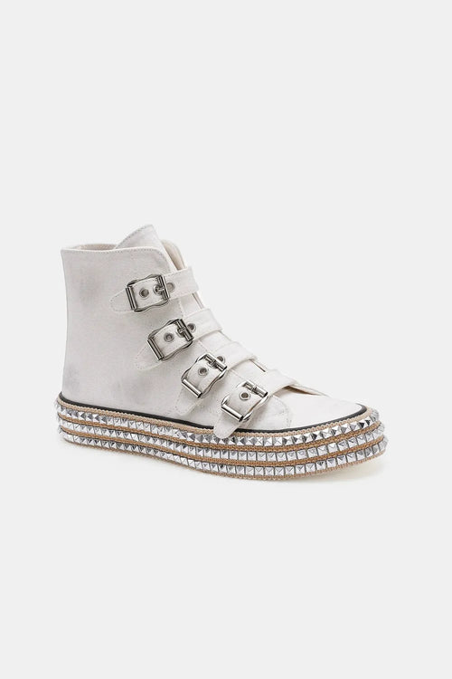 Light gray platform sneakers with three metal buckle straps and studded sole