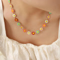 Gold-tone flower necklace with multicolor enamel daisy drops