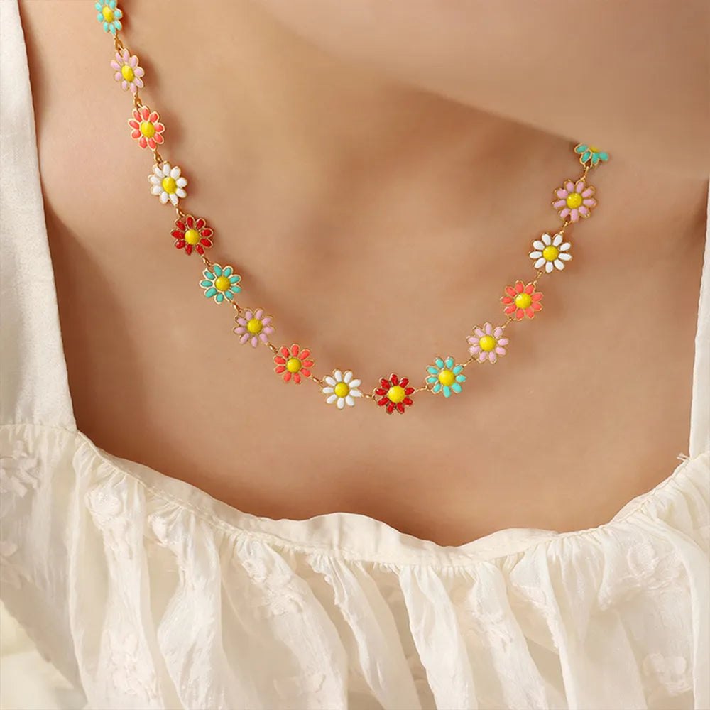 Gold-tone flower necklace with multicolor enamel daisy drops