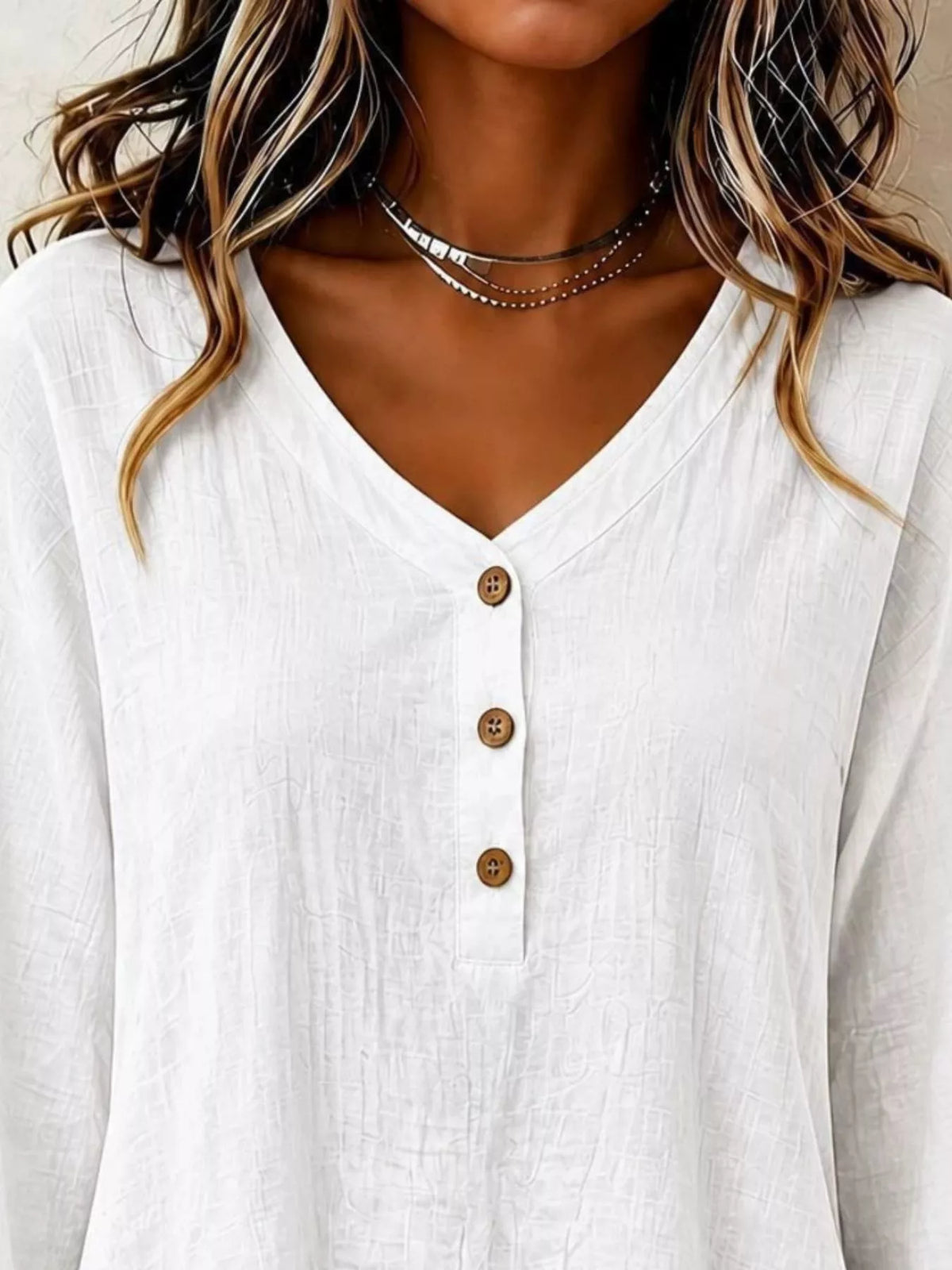 White V-neck button-front long-sleeve blouse with three wood-look buttons