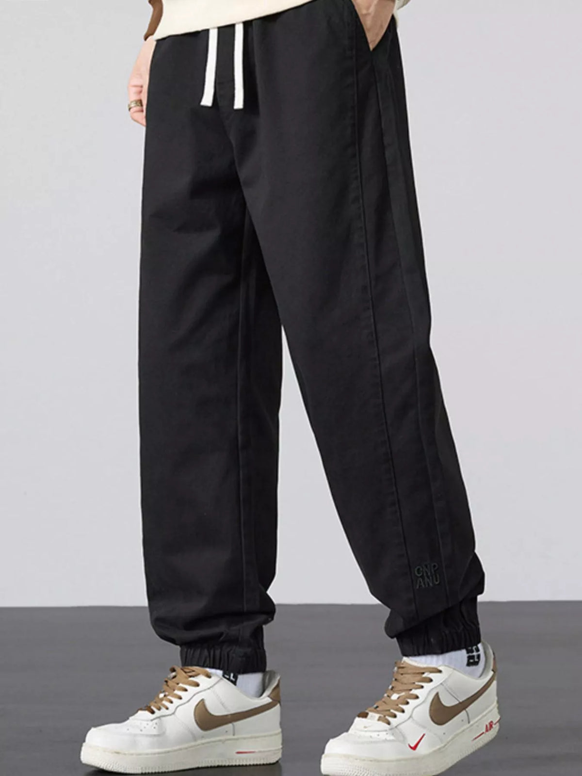Men's casual loose-fit black jogger pants with drawstring and ankle cuff