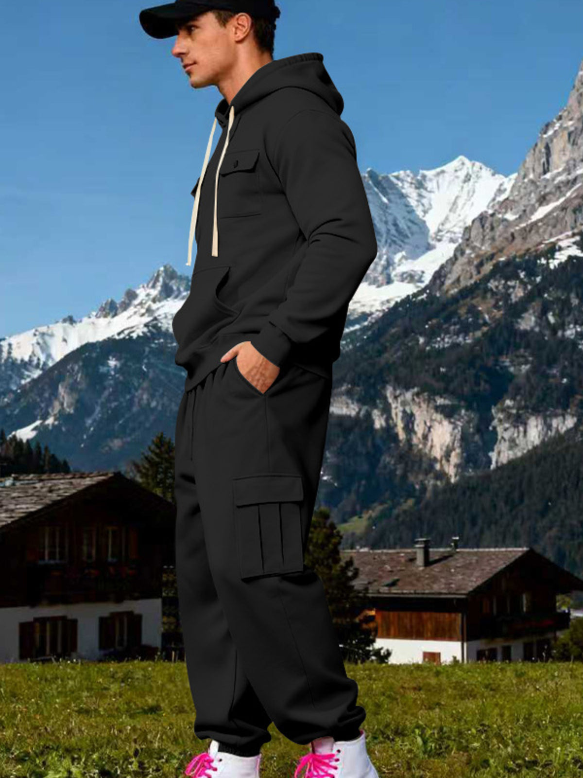 Two-piece kangaroo hoodie set: black hoodie and black cargo sweatpants, side profile