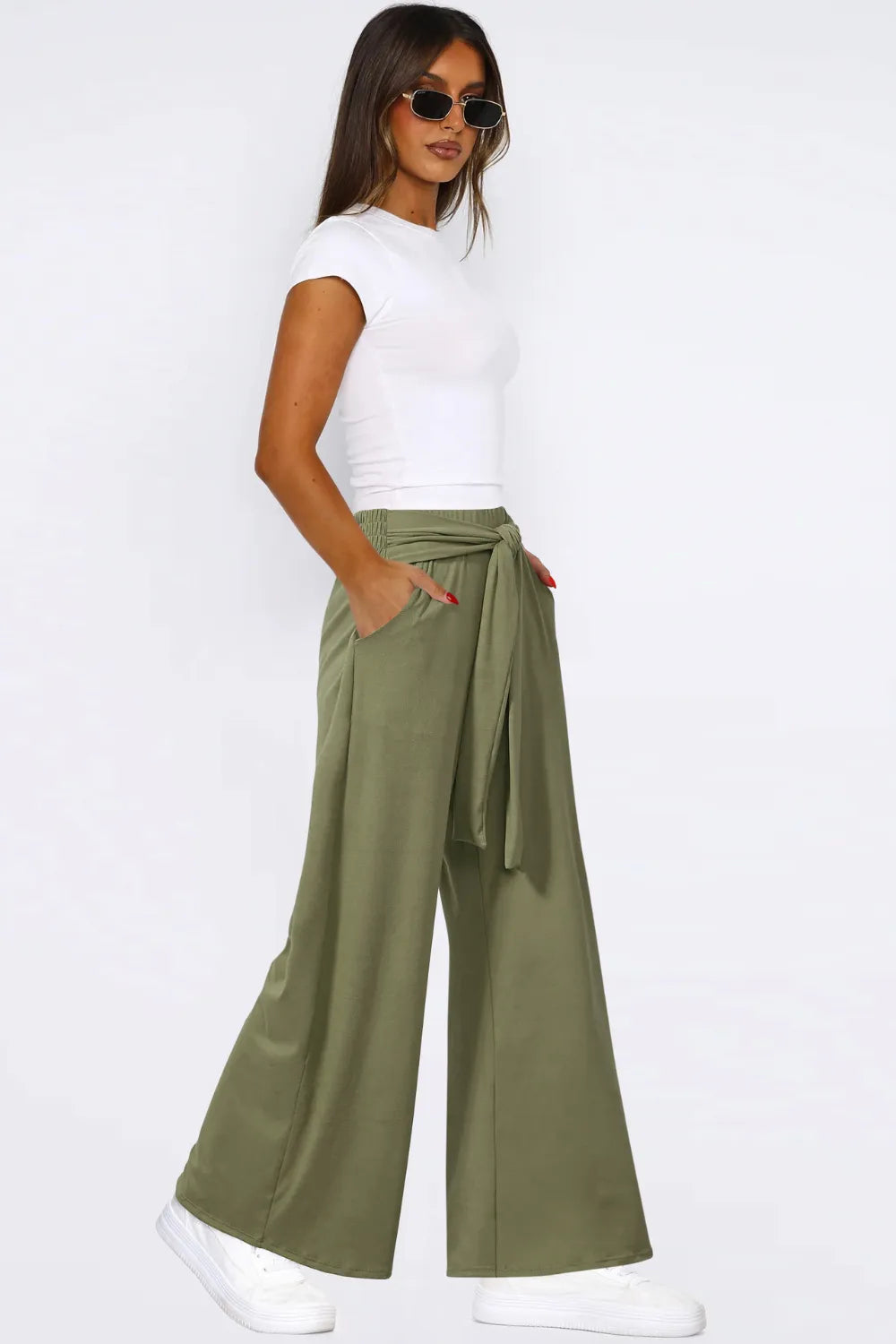 Moss green wide-leg pants with tied waist and side pockets, relaxed wide silhouette.