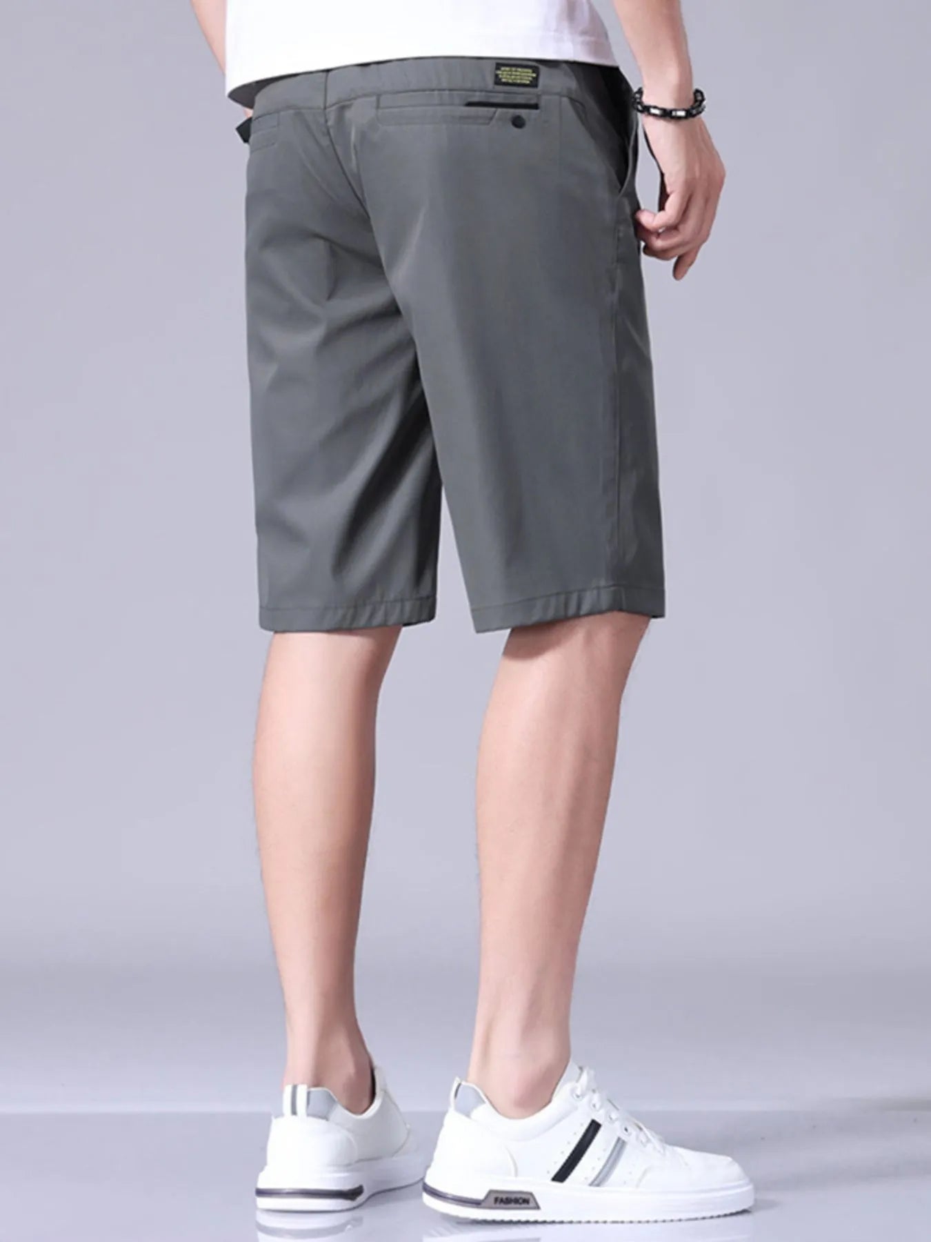 Dark gray men's casual shorts with pockets and belt loops, knee-length
