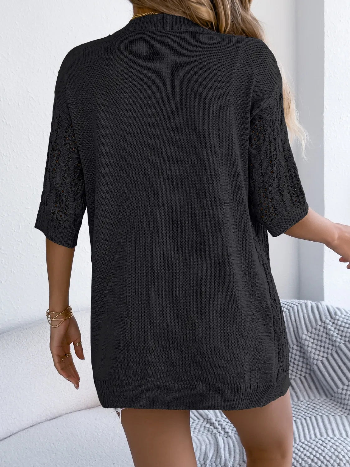 Black open-front half-sleeve cardigan, openwork knit back view