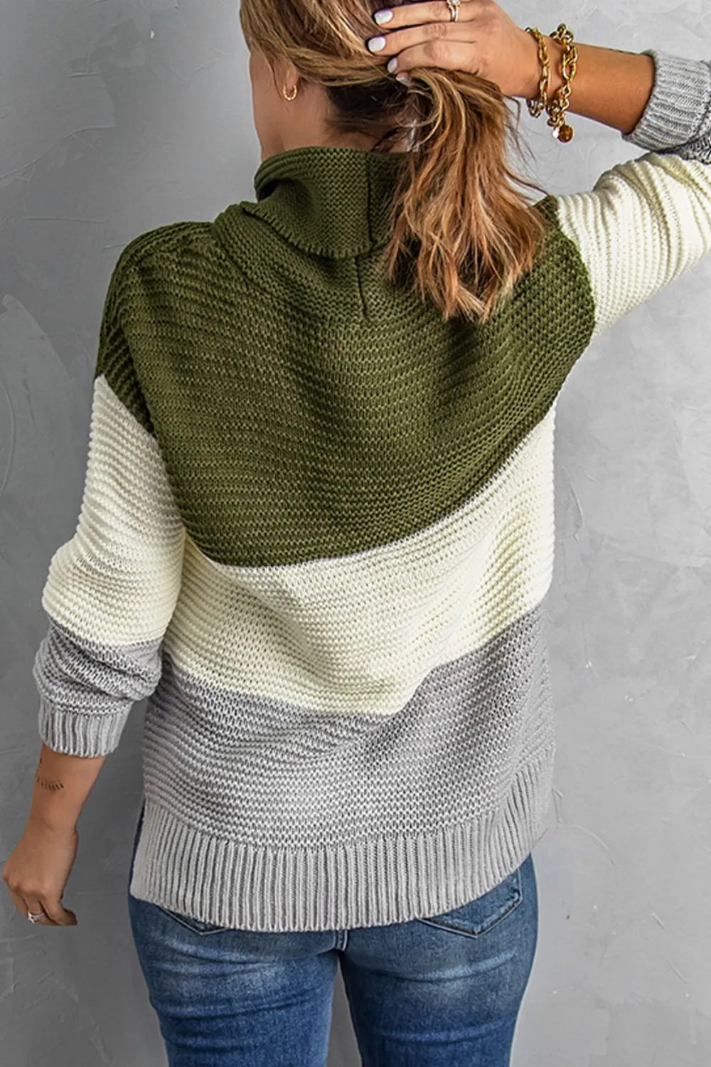Color-block turtleneck sweater with moss green cowl neck and cream/gray color blocks