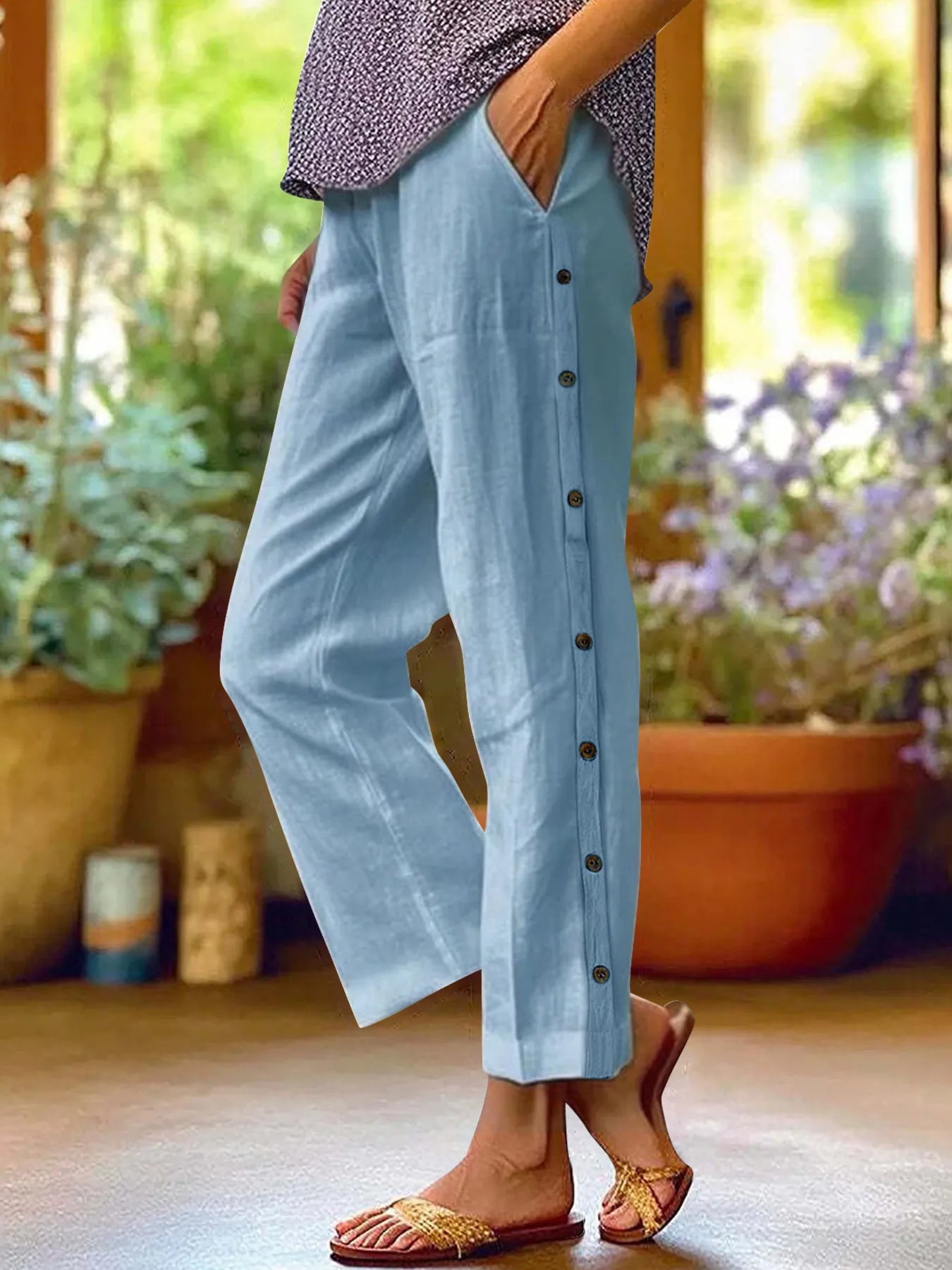 Sky blue wide-leg pants with side button detail and elastic waist