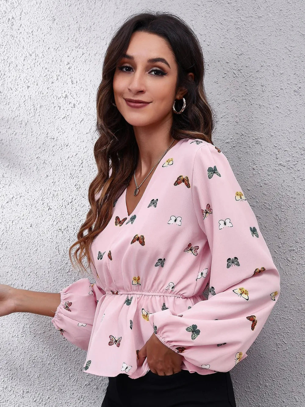 Blush pink butterfly print peplum blouse with gathered waist and balloon sleeves