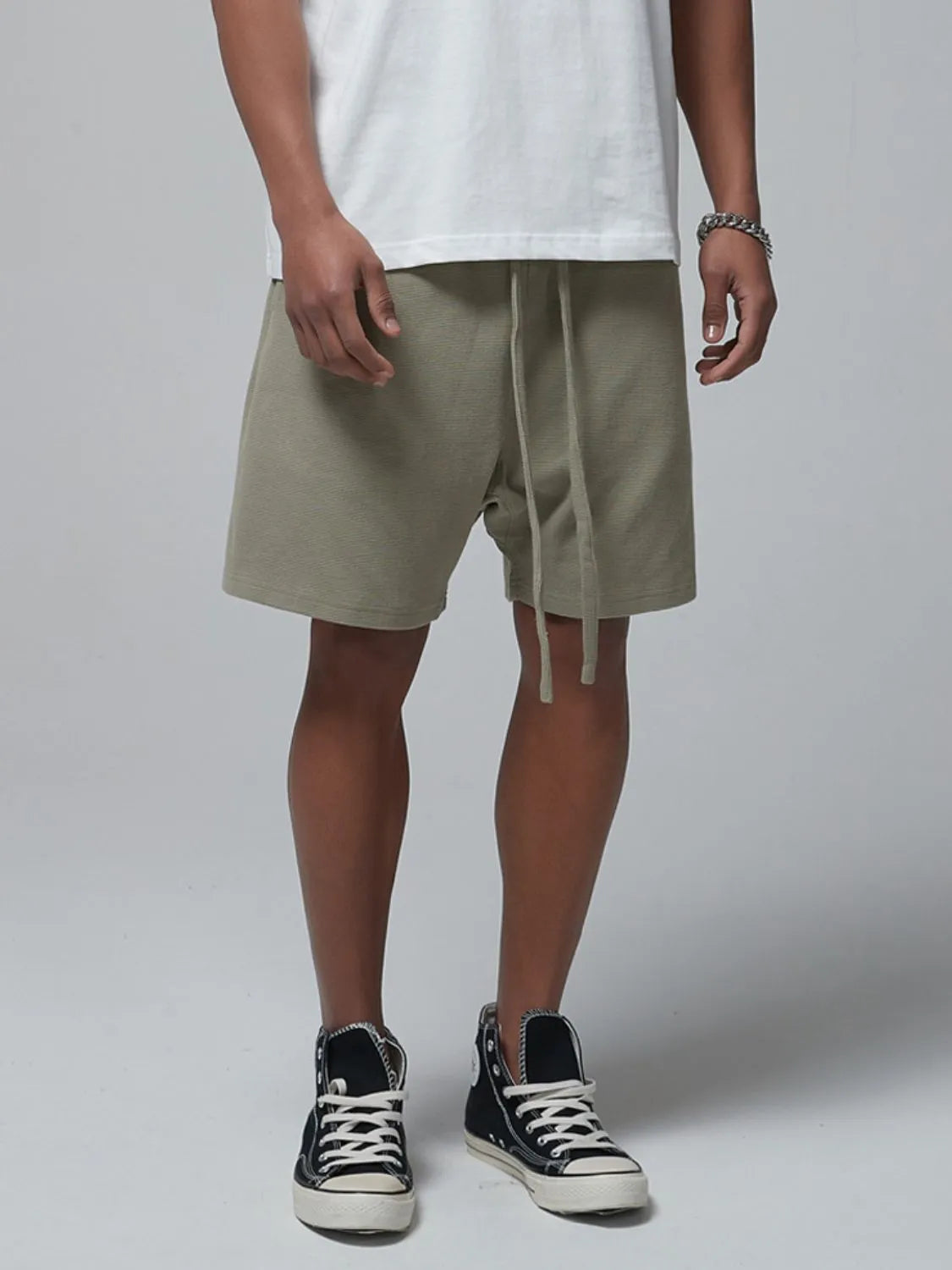 Men's sage waffle shorts with drawstring tie and side pockets, relaxed fit