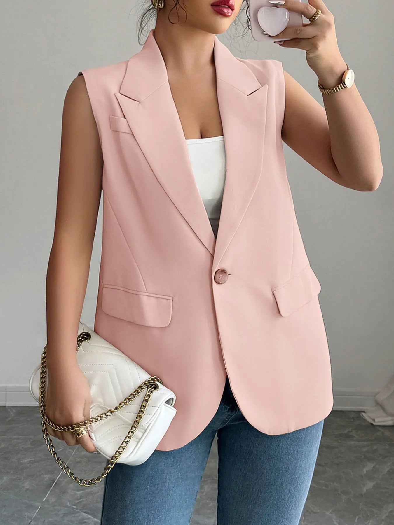 Pale blush sleeveless blazer with one button and flap pockets
