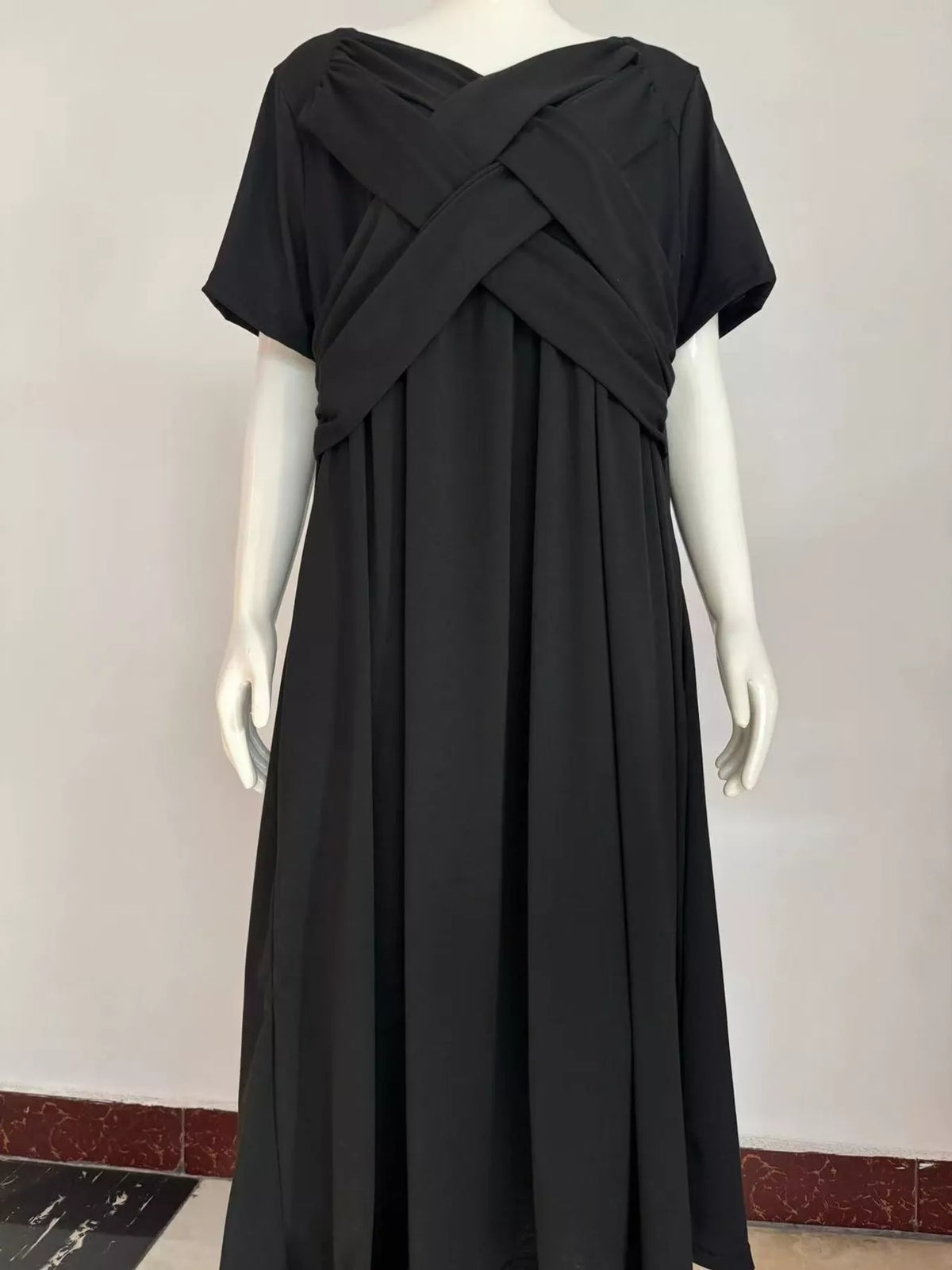 Black crisscross high-waist midi dress on mannequin, short sleeves and V neckline