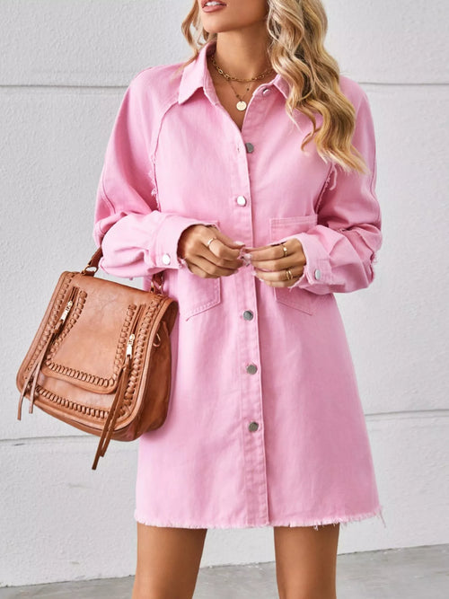 Blush pink button-down denim shirt dress with collar, chest pockets, and raw frayed hem