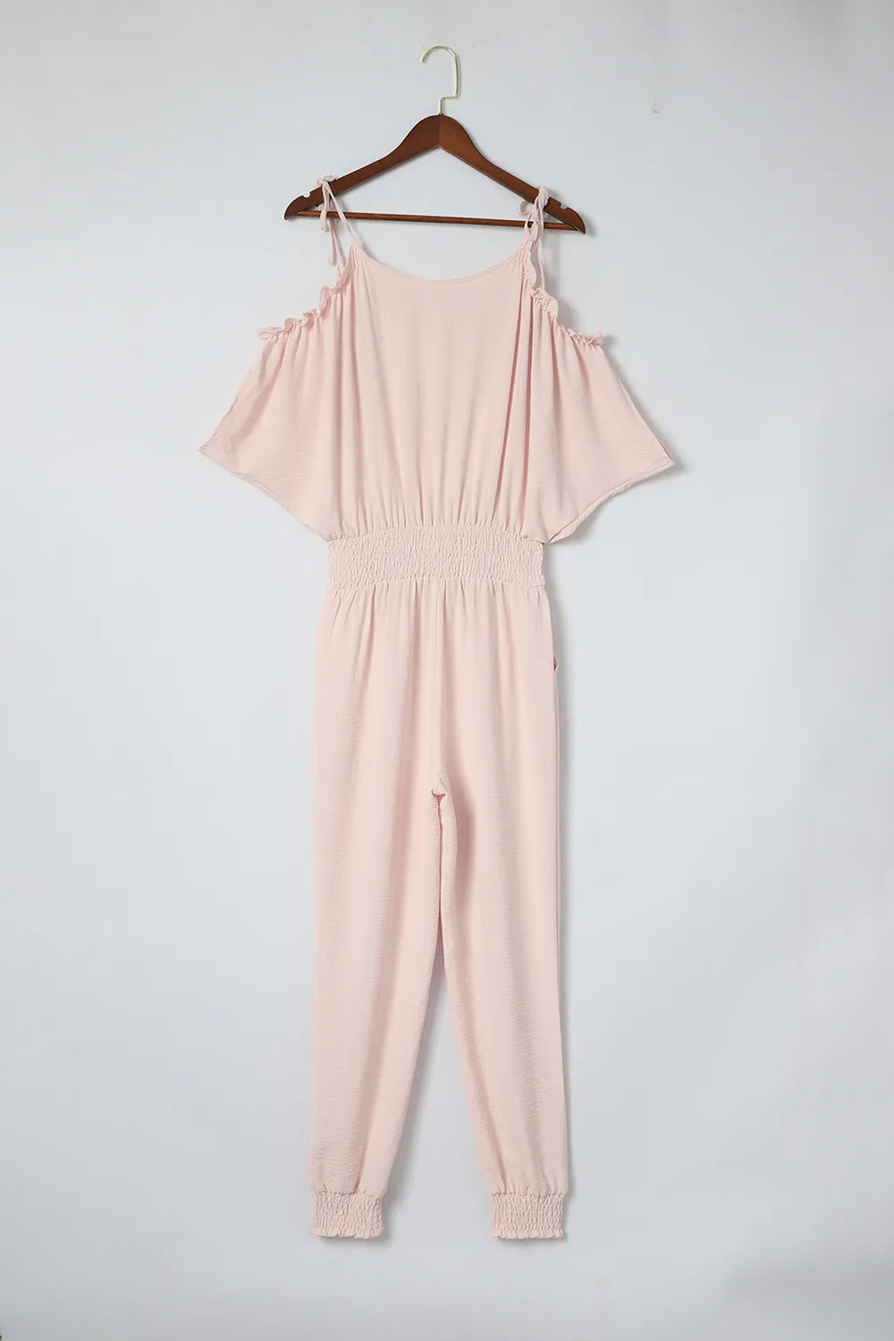 Pink cold-shoulder frill surplice jumpsuit front view, elastic waist and jogger cuffs