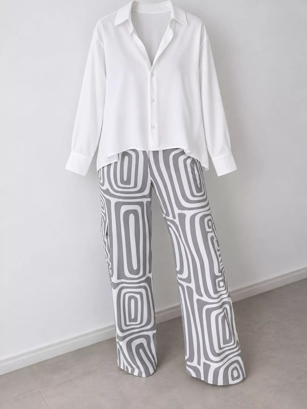 Button-down shirt and patterned pants set: white top, gray geometric trousers.