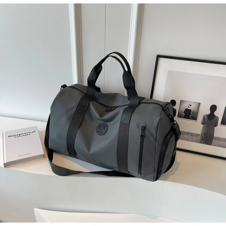 Dark gray large waterproof duffel bag with black handles and front zipper pocket