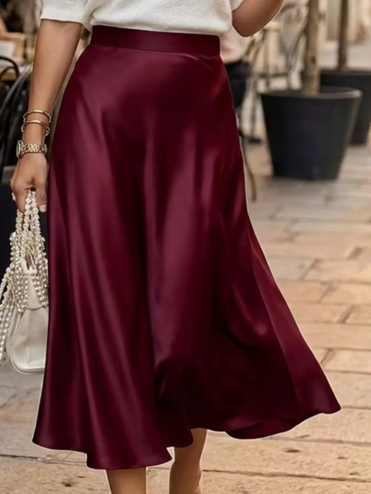 High-waist satin midi skirt in wine red, mid-calf length with gentle A-line flare.