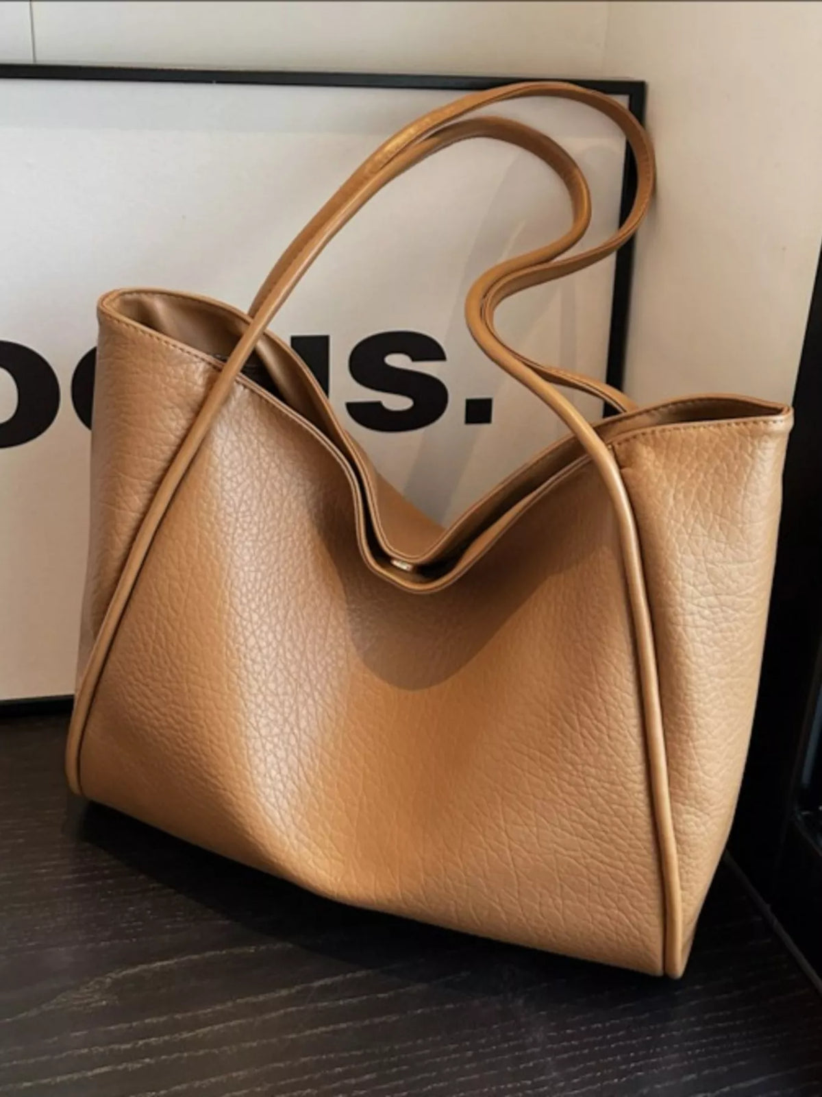 Khaki vegan leather tote bag with U-shaped front and long strap handles
