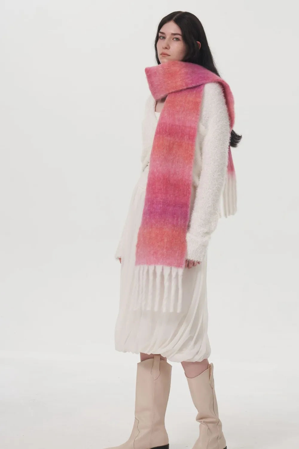 Pink gradient thermal scarf draped over shoulders with long fringe ends.