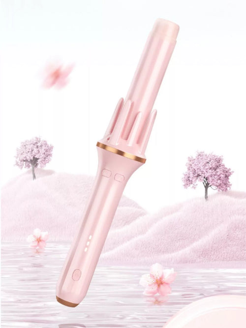 Automatic rotating hair curling iron in blush pink with gold-tone barrel tips