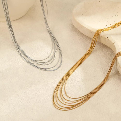 18K silver multi-layer necklace with five thin chain strands on display