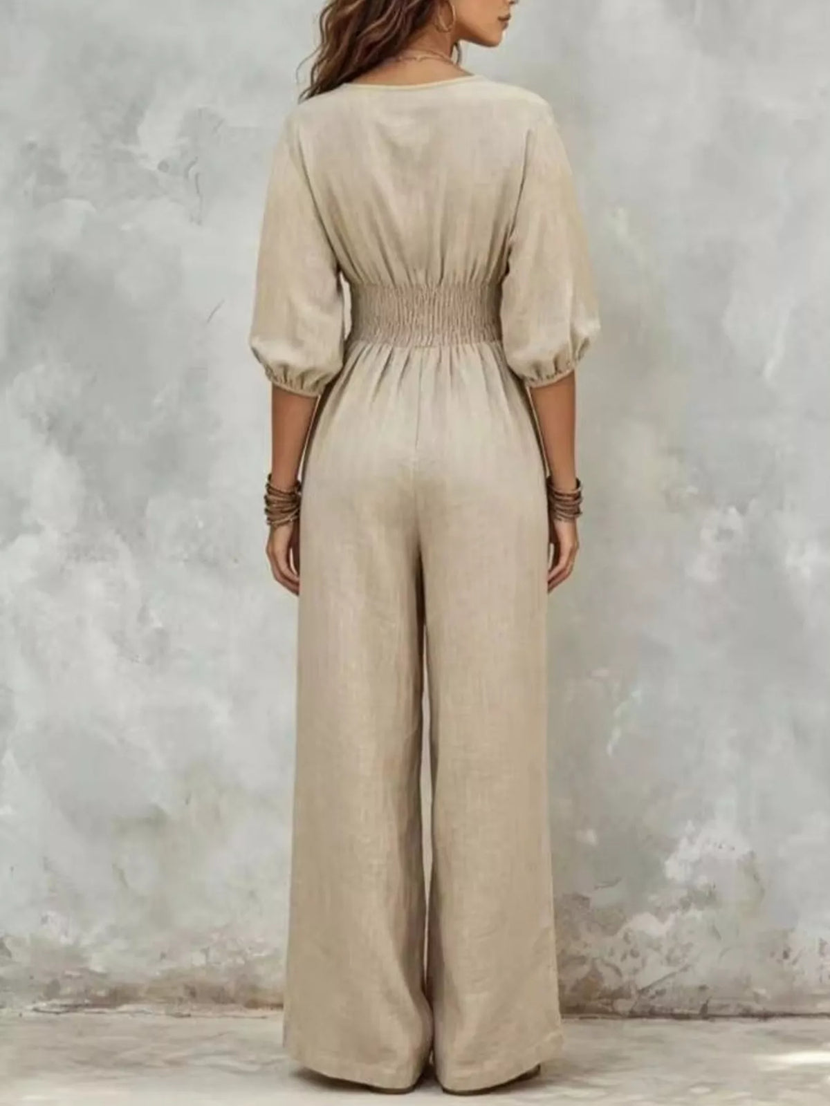 White v-neck smocked-waist wide-leg jumpsuit, back view