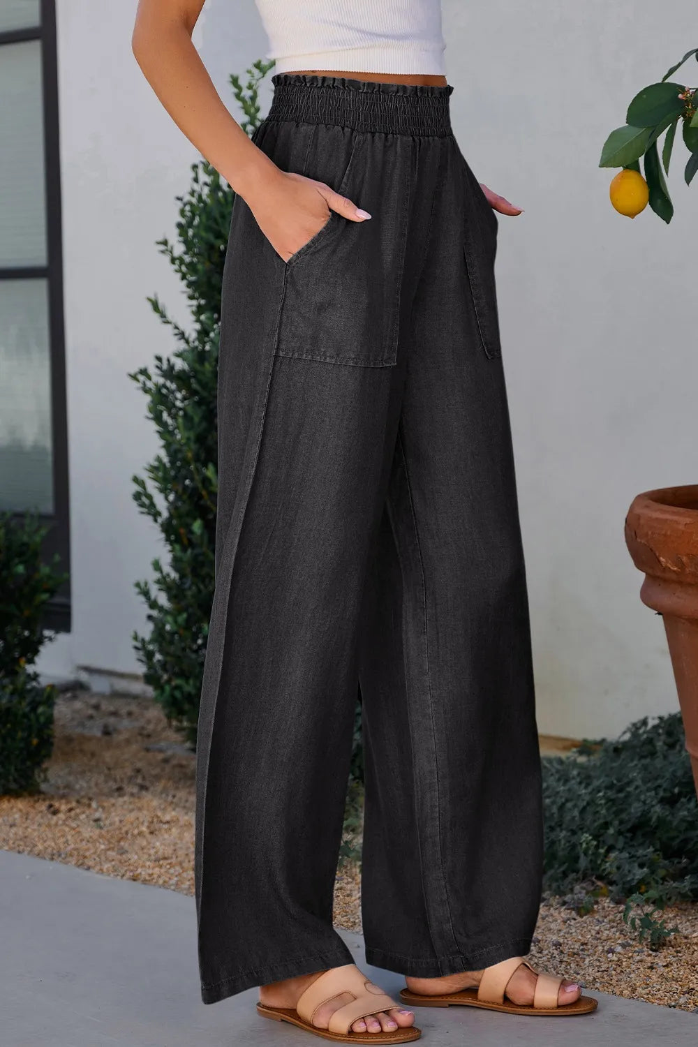 Black wide-leg pants with smocked high waist and side pockets