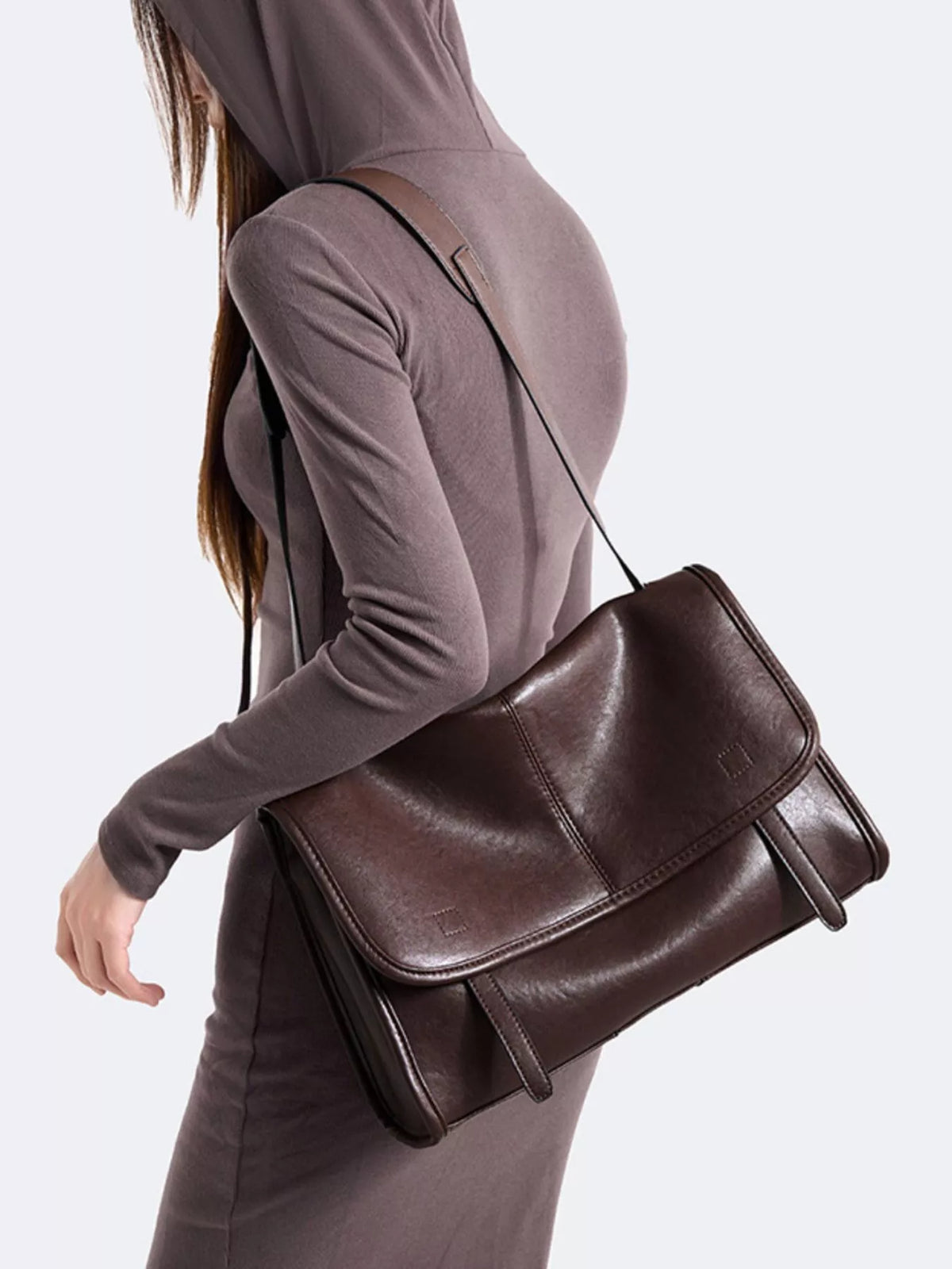 Brown messenger bag with fold-over front flap and adjustable crossbody strap