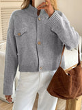 Light gray knit cardigan with button front, flap pockets, ribbed high collar and cuffs