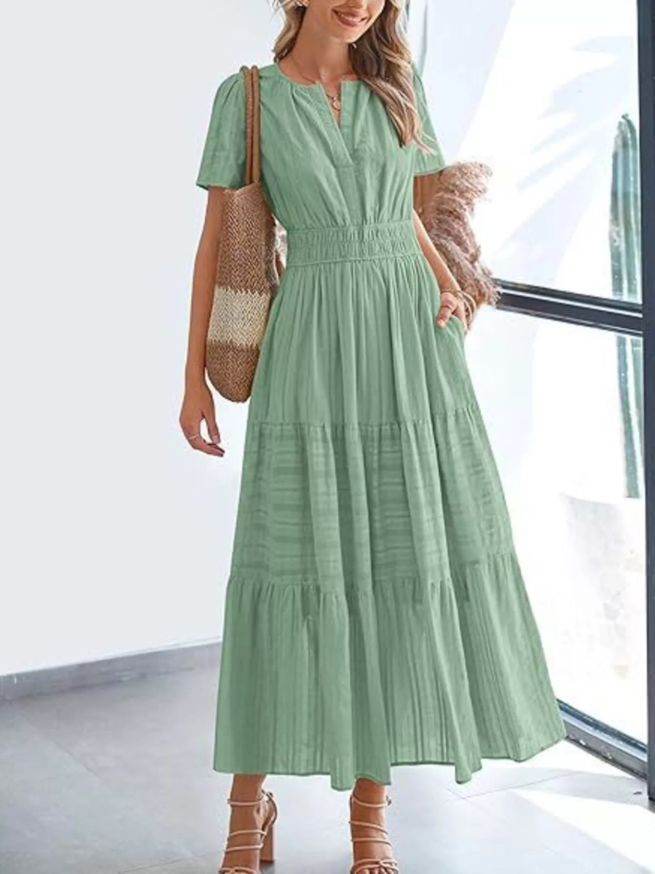 Tiered midi dress in sage green, short sleeves, V-neck, smocked waist, tiered skirt.