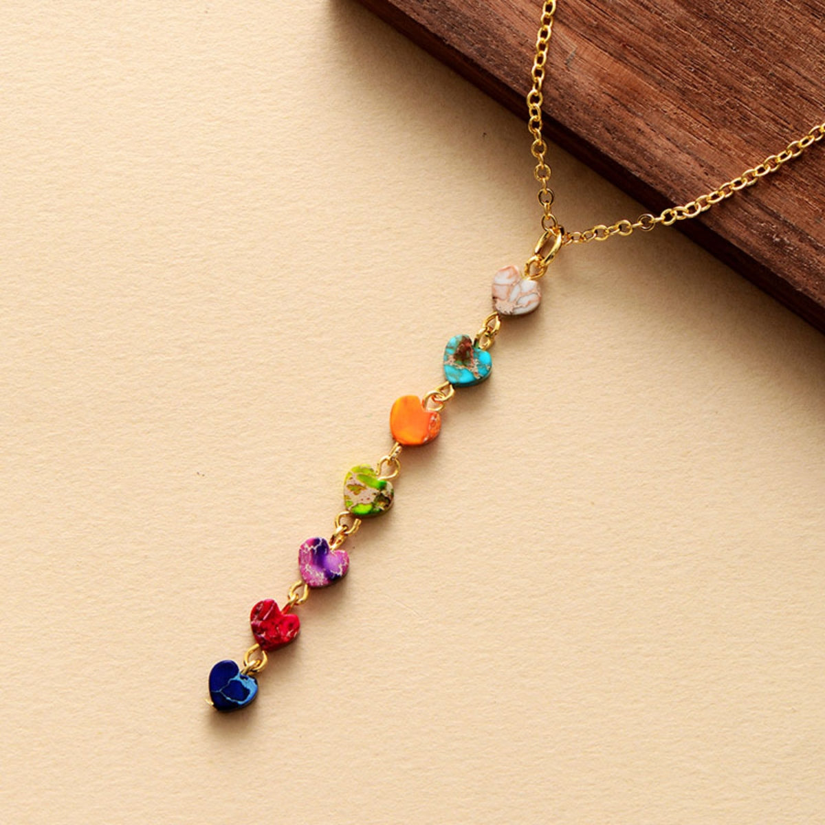 Gold-tone chain necklace with multicolor heart-shaped stone beads and clasp