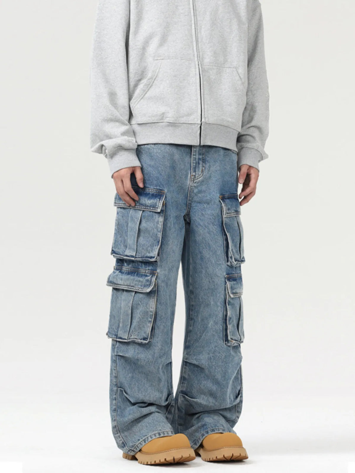 Blue washed cargo jeans with large side flap pockets and relaxed wide legs