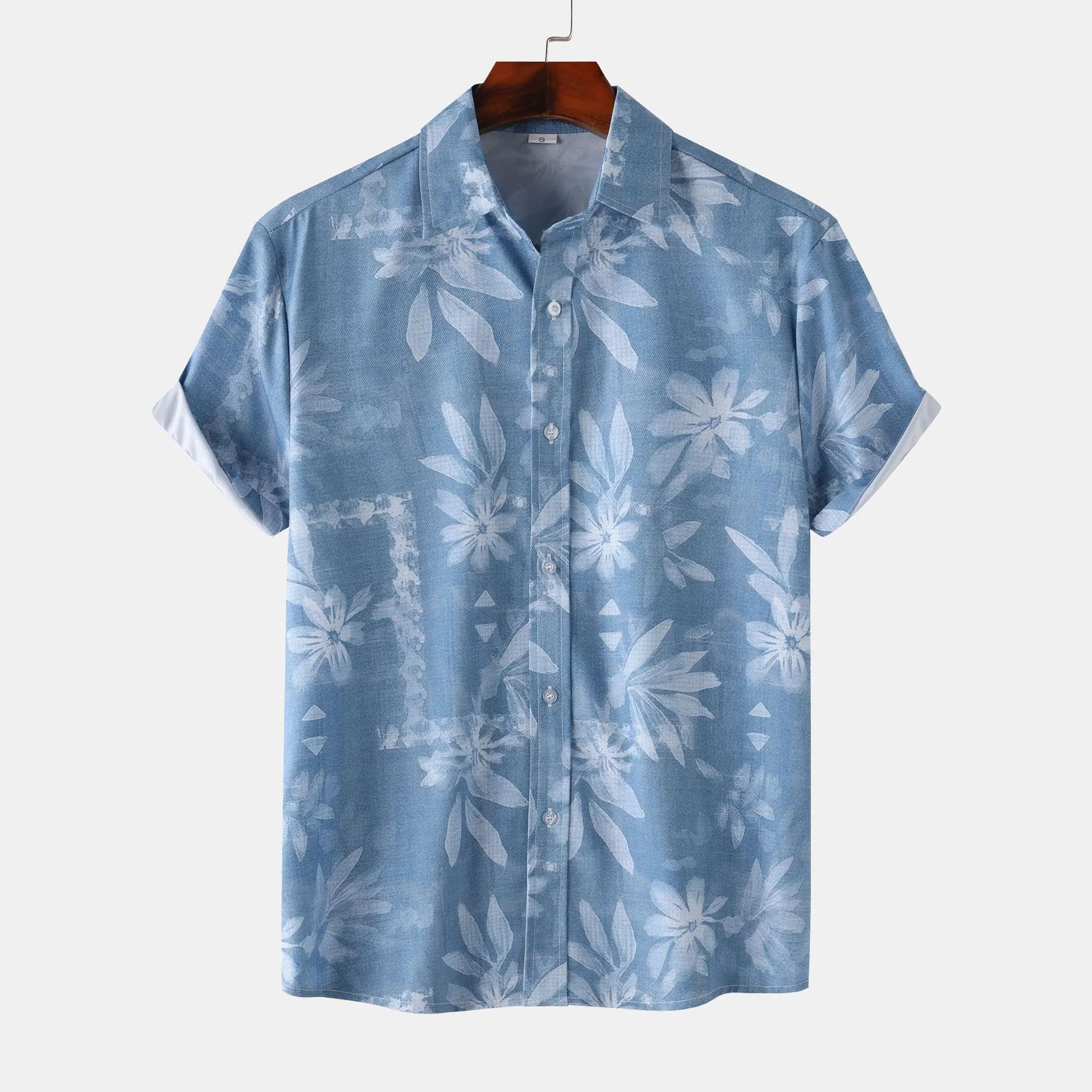 Men’s printed short-sleeve button-up shirt in blue with light floral leaf pattern.