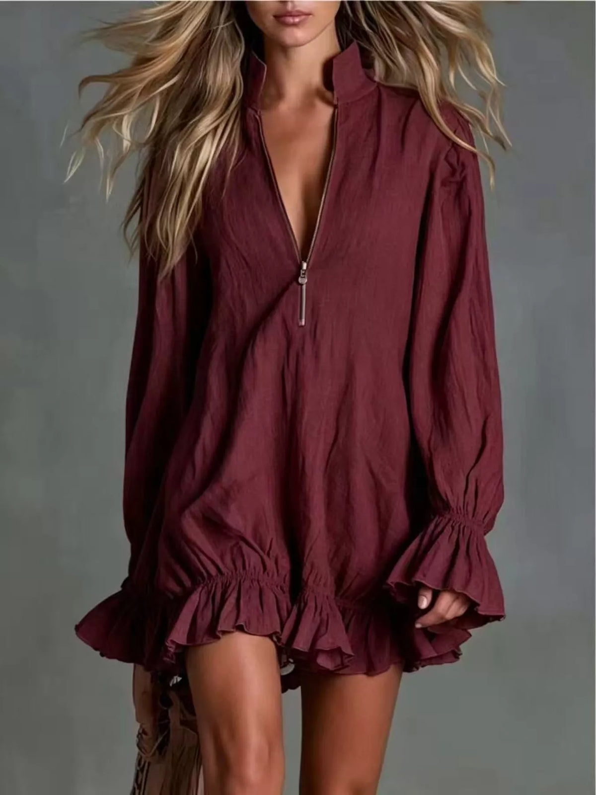 Burgundy mini dress with front zipper and ruffled hem, long puff sleeves and elastic cuffs