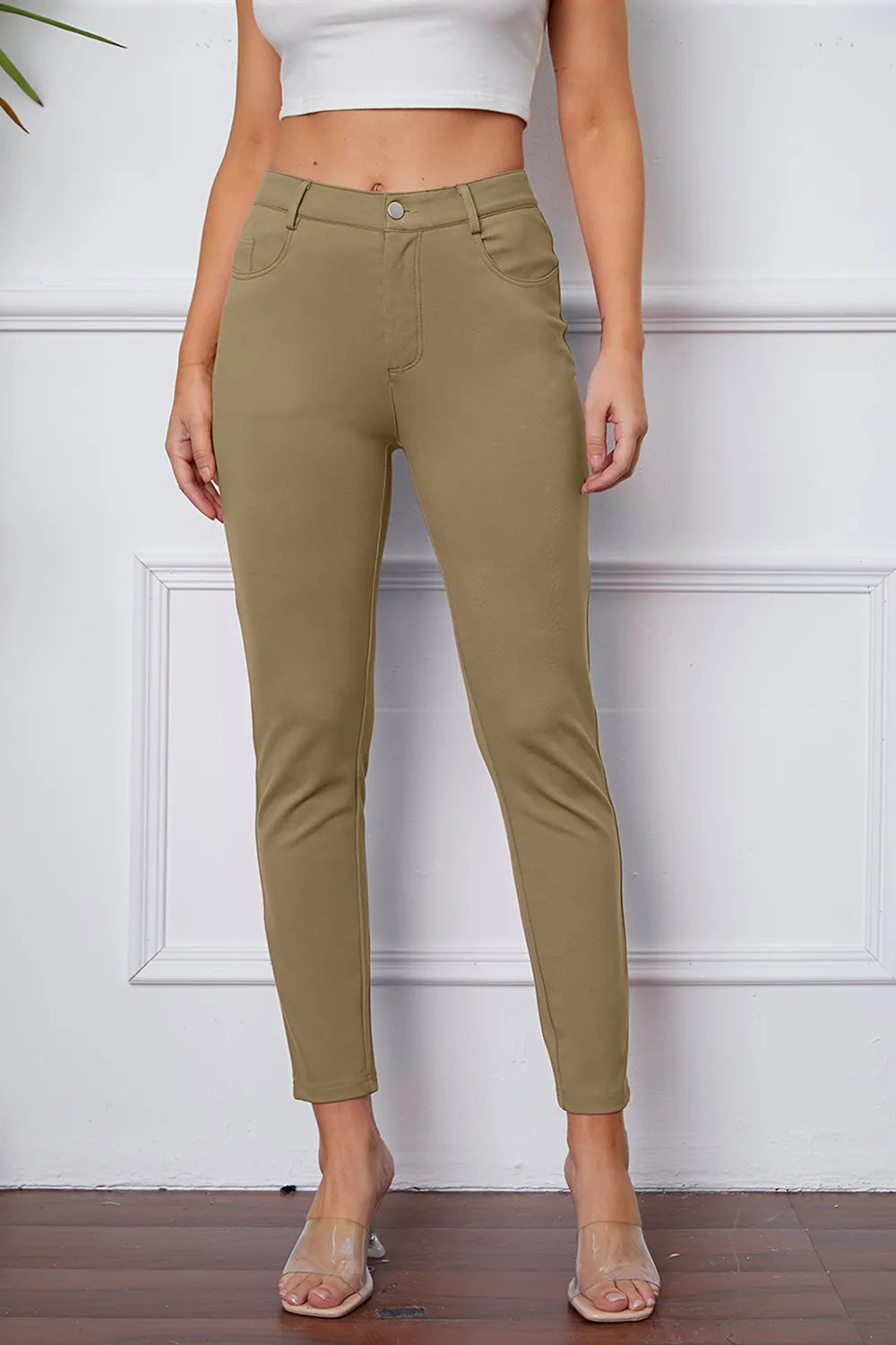 Women's khaki stretch pants with button, belt loops, and ankle-length slim fit