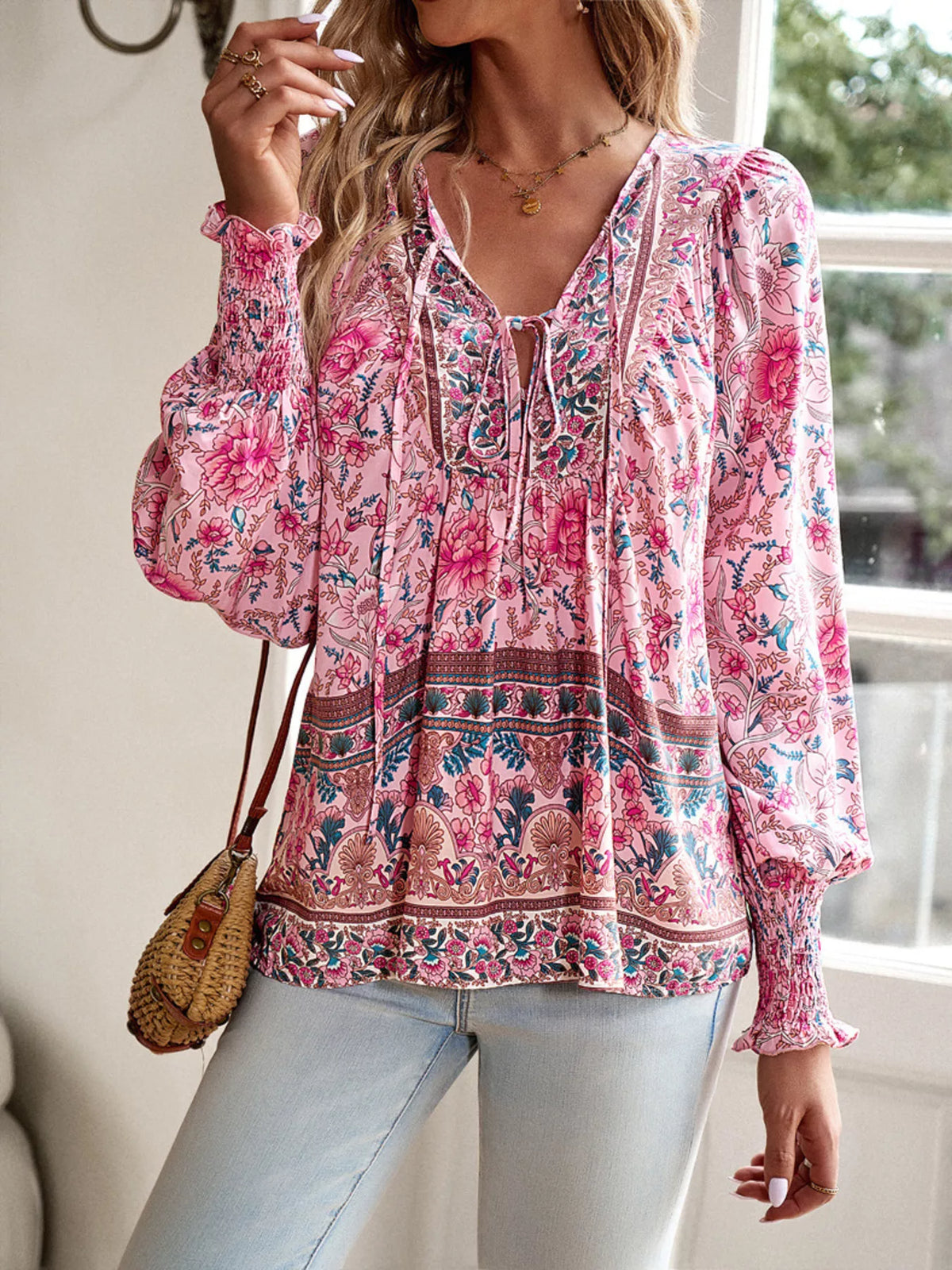 Pink floral tie-neck blouse with gathered yoke and long puff sleeves with smocked cuffs