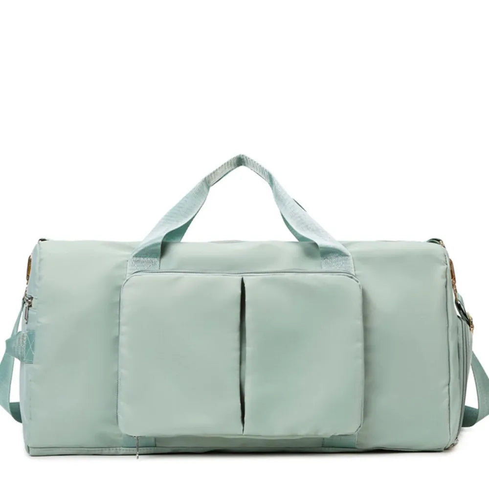 Large travel duffel bag with front zip pocket, mint green body and side carry straps